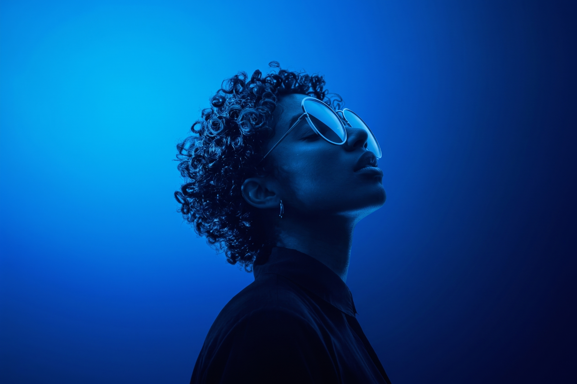 Person looking up to the sky, portrait rendered in blue tones